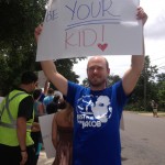 Man holds a sign in support of Jacob Lavoro, a teen facing up to 99 years for hash oil brownies